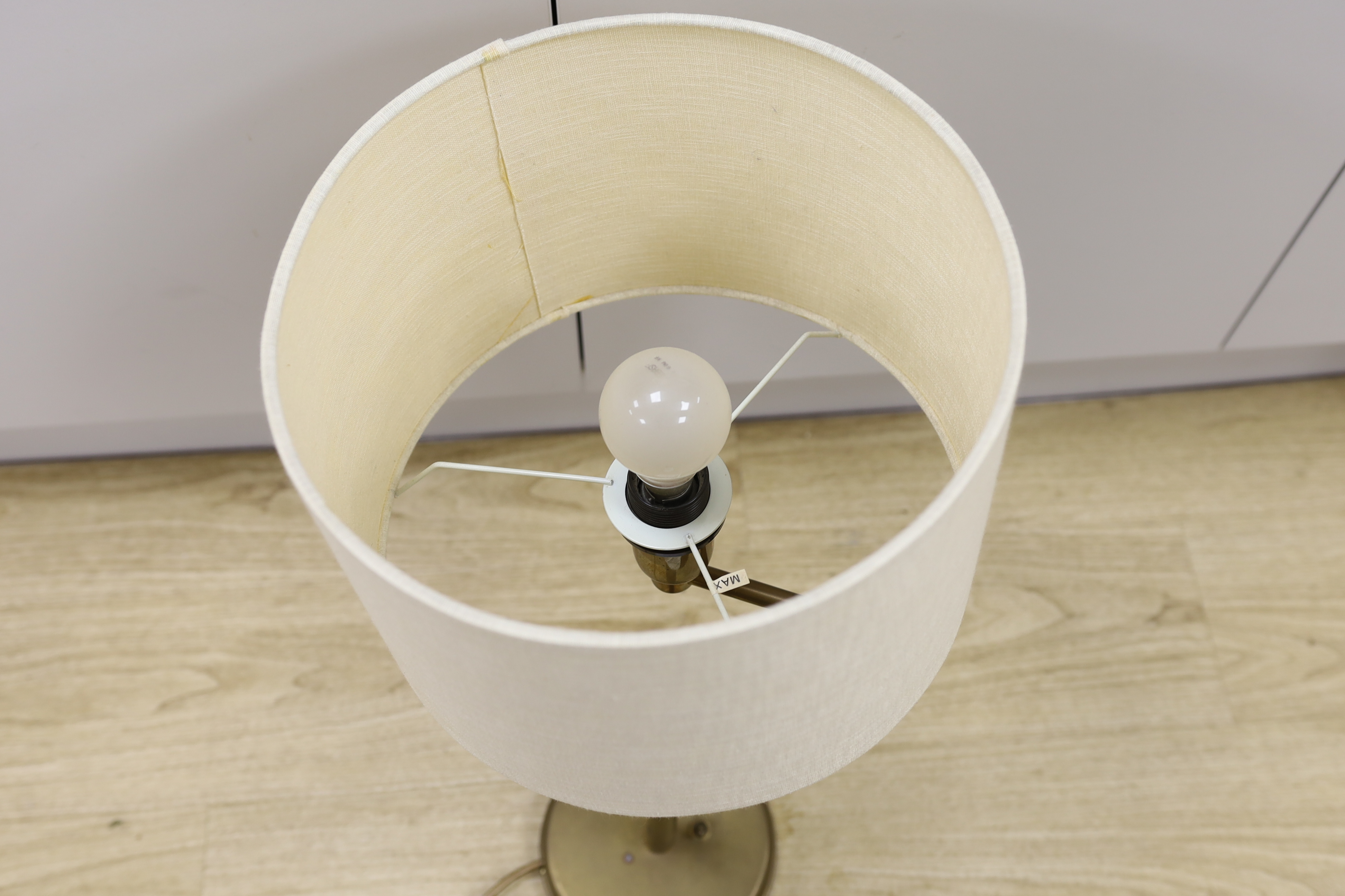 A brass swivel arm table lamp